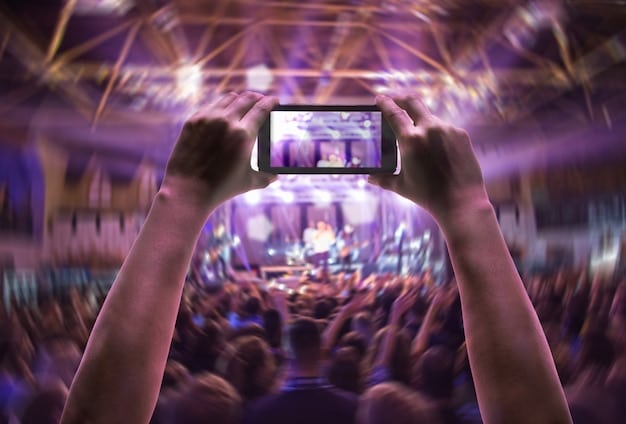 A concert stage with thousands of fans holding up illuminated smartphones, capturing the performance of a pop star, representing the widespread reach and cultural impact of music.