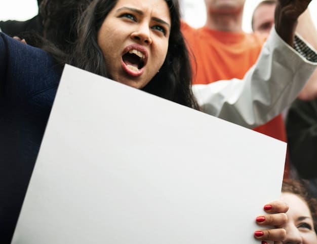A protest sign held by a fan at a public event reads 