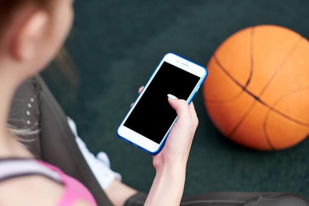A close-up shot of a smartphone screen displaying a sports news article about NIL deals, with a college athlete profile visible. In the background, subtly blurred, are outlines of university buildings.