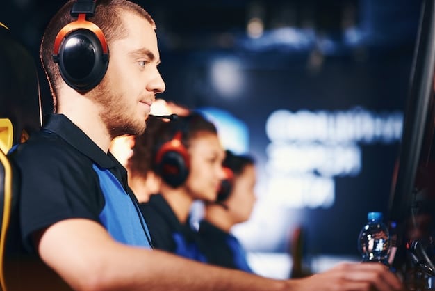 A professional esports player intensely focused on their gaming setup, surrounded by high-end equipment, with a crowd visible in the blurred background.