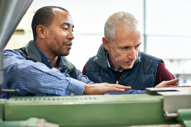 A diverse group of US manufacturing workers collaborating on a new robotic system. One worker is programming a robot arm, while another is reviewing data on a tablet. The team appears engaged in problem-solving and innovation, highlighting human-robot collaboration.