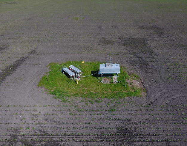 A detailed aerial view of a meticulously planned solar farm spanning vast plains, illustrating the scale of renewable energy deployment and its minimal environmental footprint.